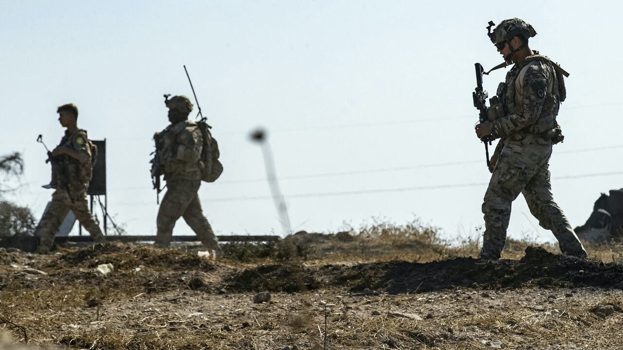 US soldiers inspect the site of reported Turkish shelling days earlier on an oil extraction facility on the outskirts of Rumaylan, in Syria's Kurdish-controlled northeastern Hasakeh province on Oct. 28, 2024. 