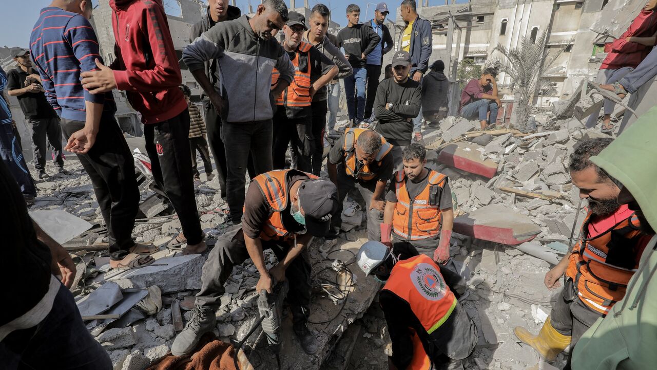 Rescue workers and civilians search through rubble in Gaza on Nov. 7, 2024, after an Israeli airstrike left devastation in a residential area. 