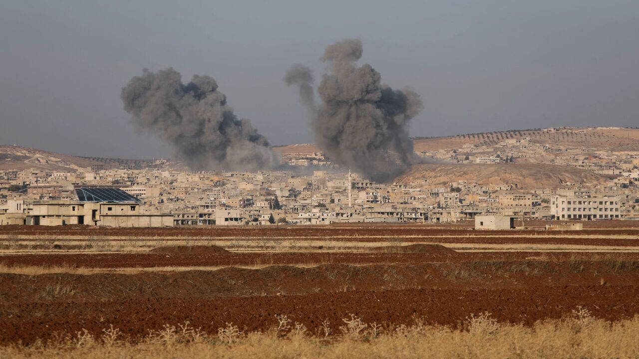 Smoke billows the the Syrian town of Suran, between Aleppo and Hama, on Dec. 3, 2024. 