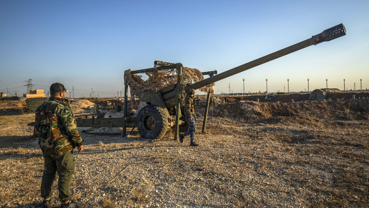 Fighters with the Kurdish-led Syrian Democratic Forces (SDF) inspect damaged and abandoned military vehicles and equipment at the Qamishli international airport, formerly a joint Syrian-russian military base, in northeastern Syria's city of Qamishli on Dec. 9, 2024.