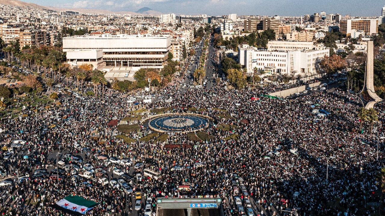 An aerial view of thousands celebrating the ouster of Syria's president Bashar al-Assad near the landmark Damascus Sword sculpture at Umayyad Square in central Damascus An aerial view of thousands celebrating the ouster of Syria's president Bashar al-Assad near the landmark Damascus Sword sculpture at Umayyad Square in central Damascus