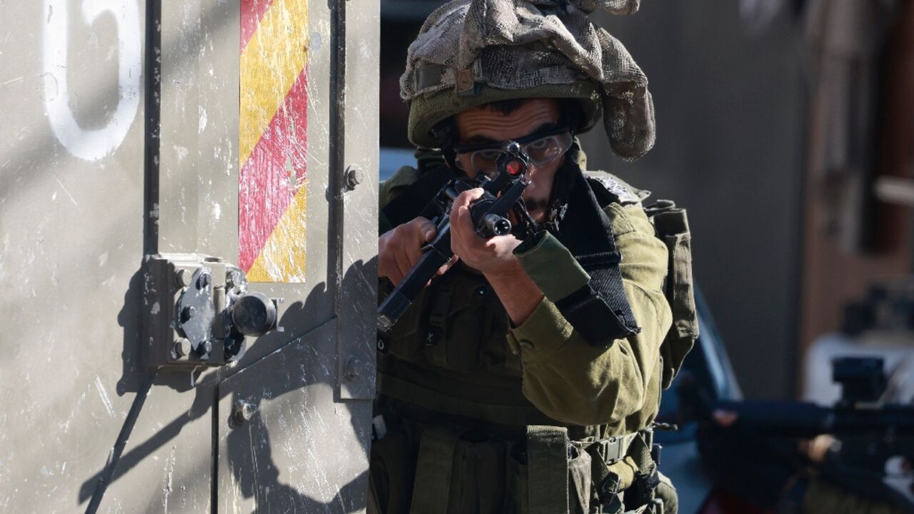 An Israeli soldier takes aim outside the Turkish hospital in Tubas in the occupied West Bank An Israeli soldier takes aim outside the Turkish hospital in Tubas in the occupied West Bank