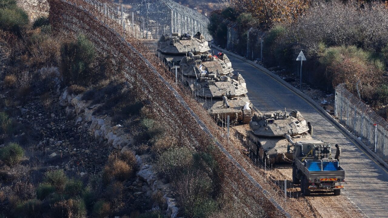 Israeli tanks take position on the border with Syria on the day Benjamin Netanyahu said he ordered the seizure of a buffer zone