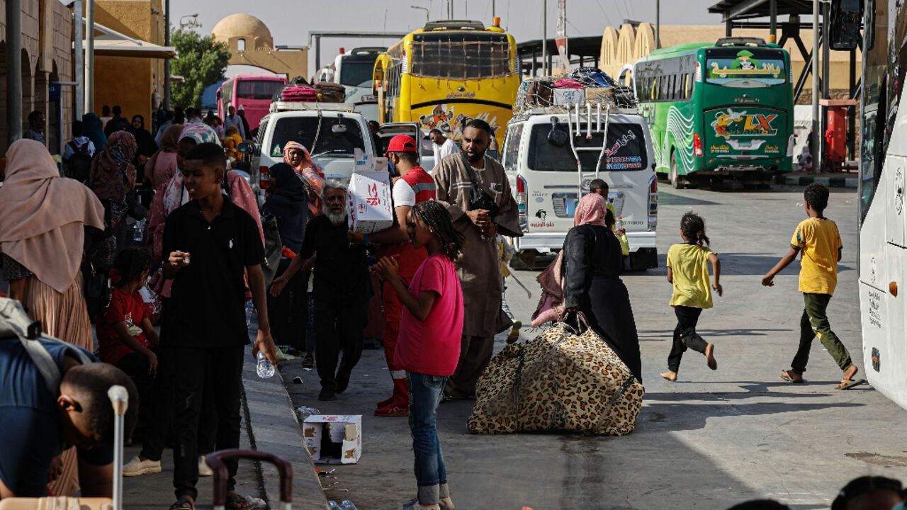 People fleeing war-torn Sudan arrive at Qastal land port crossing to Egypt in May last year.  The UN says Egypt is home to more than 845,000 registered refugees and asylum seekers from Sudan 