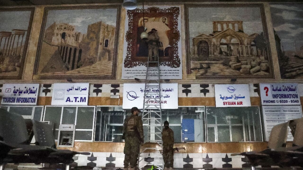 Anti-regime fighters tear off a poster depicting Syrian President Bachar al-Assad and his brother Maher at the airport in the northern Syrian city of Aleppo Anti-regime fighters tear off a poster depicting Syrian President Bachar al-Assad and his brother Maher at the airport in the northern Syrian city of Aleppo