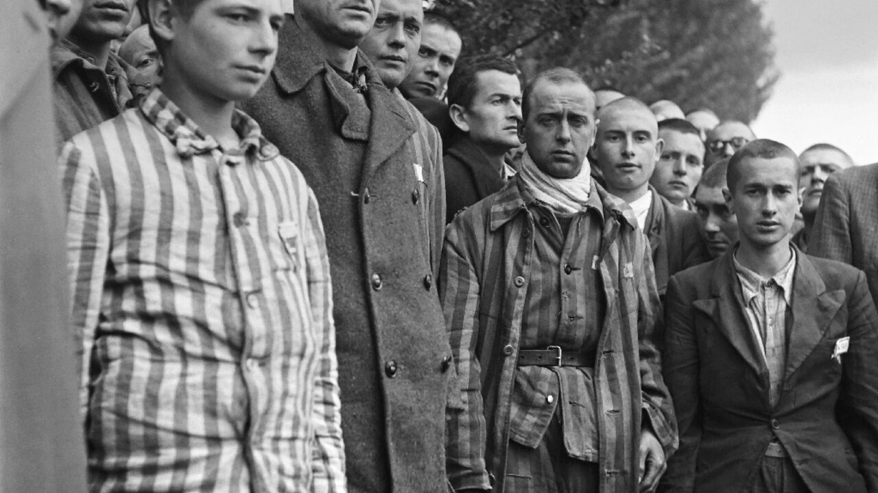 French prisoners at the Dachau concentration camp near Munich observe a minute's silence after its liberation in 1945