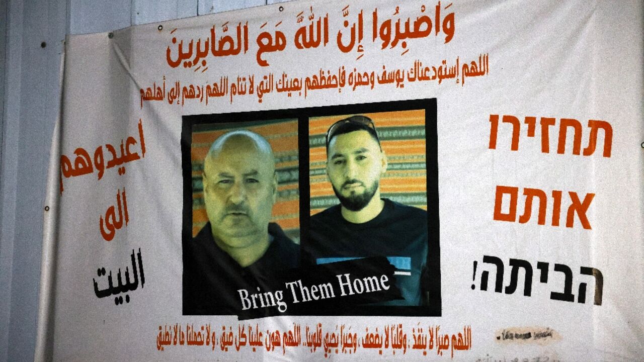 A banner calling for the release of Bedouin Arab hostages Youssef and Hamza al-Zayadna in Arabic and Hebrew hangs outside the family's home in the Israeli city of Rahat.