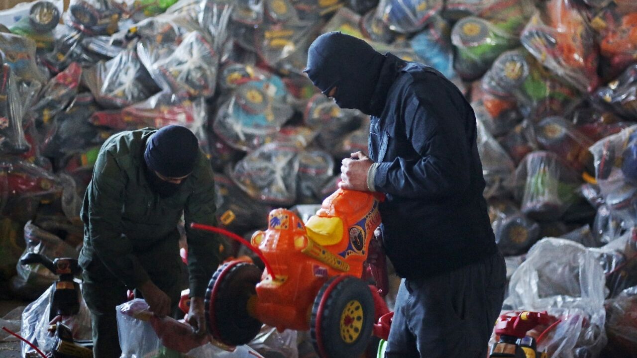 Syrian security personnel at a warehouse in Latakia examine toys used to hide the drugs