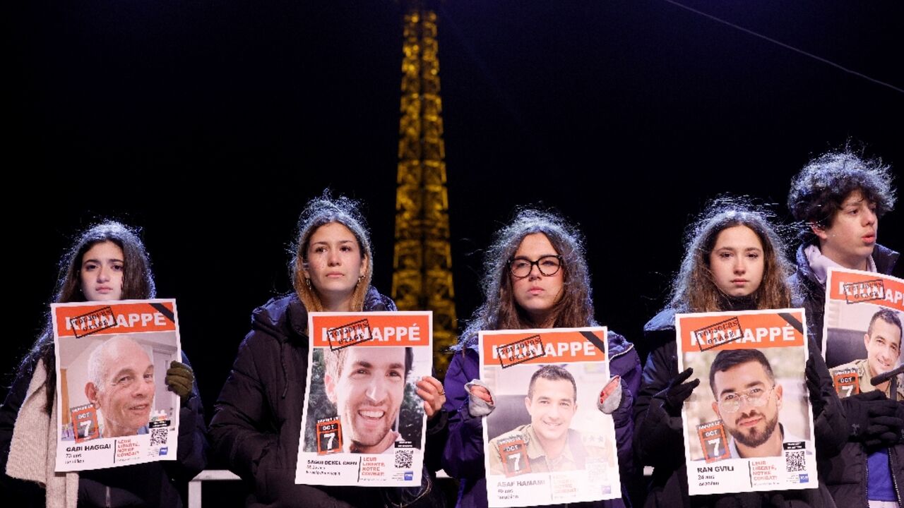 Some of those present carried photos of the hostages under a sign saying 'abducted'