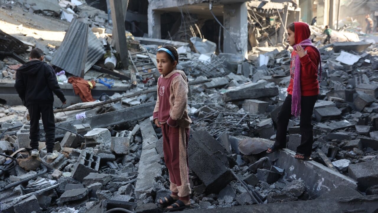Palestinian children inspect damage after an Israeli strike in Jabalia, in the north of Gaza where several displaced Gazans said they also fear falling temperatures and heavy rains Palestinian children inspect damage after an Israeli strike in Jabalia, in the north of Gaza where several displaced Gazans said they also fear falling temperatures and heavy rains