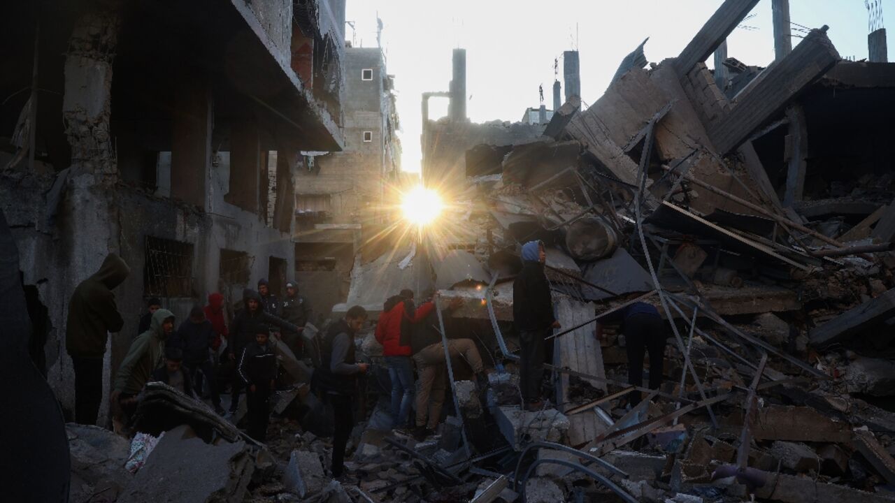 Palestinians scour the rubble of a house destroyed in an Israeli strike on Bureij refugee camp in central Gaza.