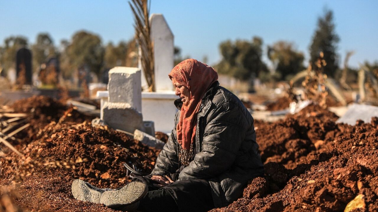 Fairuz Shalish by an unmarked grave at a cemetery in Homs that she believes might hold her son Fairuz Shalish by an unmarked grave at a cemetery in Homs that she believes might hold her son