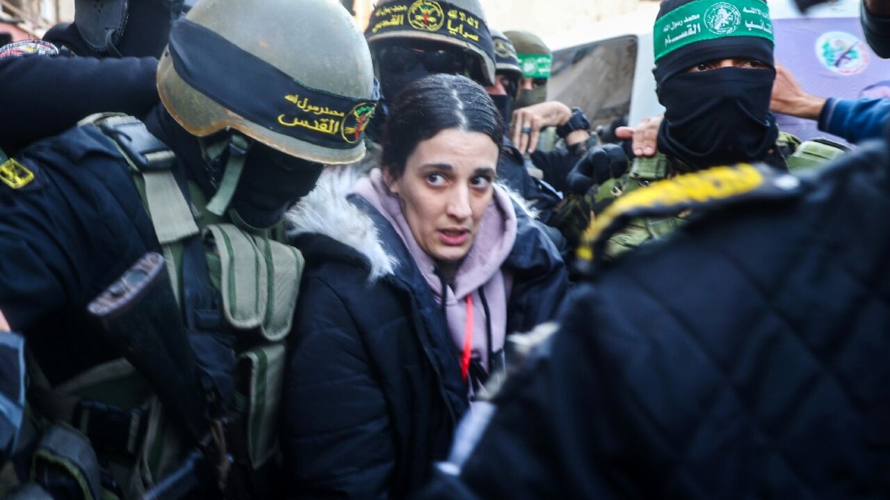 Masked fighters of Hamas and its ally Islamic Jihad struggle to clear a path through crowds of Palestinian spectators for Israeli civilian Arbel Yehud ahead of her release with other hostages Masked fighters of Hamas and its ally Islamic Jihad struggle to clear a path through crowds of Palestinian spectators for Israeli civilian Arbel Yehud ahead of her release with other hostages