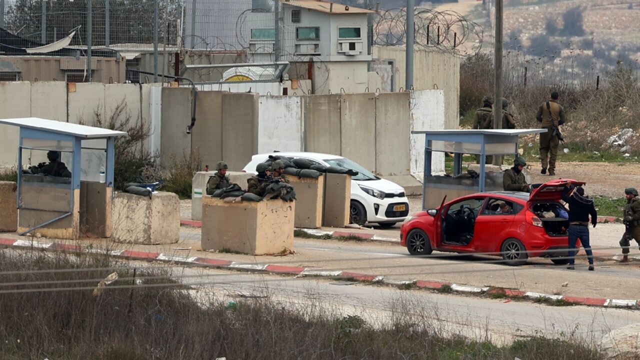 Palestinians sometimes wait hours on their way home from work while cars are searched and IDs verified