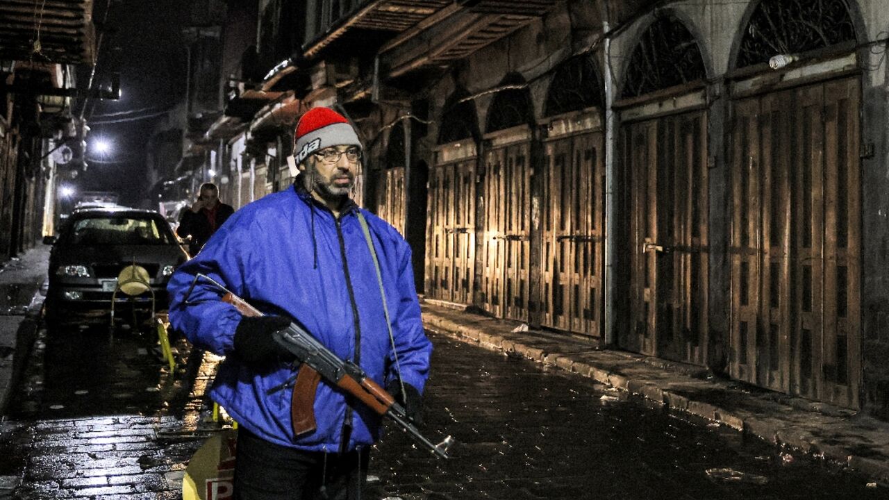 A member of a local neighbourhood watch guards his neighbourhood in Damascus