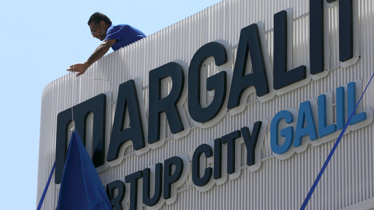 This picture taken on September 2, 2021 shows the unveiling of the logo of the Margalit Startup City Galil street foodtech event in the northern Israeli town of Kiryat Shmona. - An innovation centre aimed at fostering "revolutions" in sustainable food opened in northern Israel on September 2 by one of the country's leading entrepreneurs, spurred by a "meteoric" investment surge in the sector. Companies at the Margalit Startup City Galil in Kiryat Shmona included Kinoko-Tech, which grows mushrooms on a platf