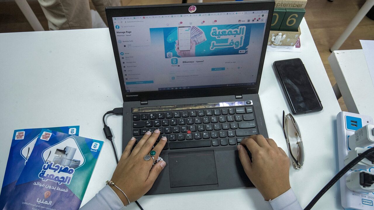 An employee at tech startup al-Gameya, uses a computer with the official Facebook page of the application open on a web browser, at the company offices in Cairo, on Sept. 12, 2021.