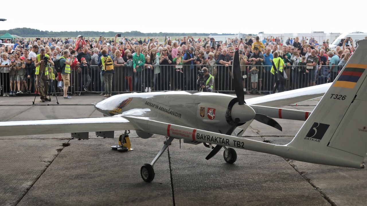 A Turkish Bayraktar TB2 combat drone is on view during a presentation at the Lithuanian Air Force Base in Siauliai, Lithuania, on July 6, 2022. - Lithuania on July 6, 2022 exhibited a crowdfunded Turkish-made military drone that it plans to send to Ukraine to help the war-torn country fight Russia's invasion. People in the NATO member country raised 5.9 million euros for the Bayraktar TB2 drone over three days last month, before its Turkish manufacturer Baykar announced it would donate the drone free of cha