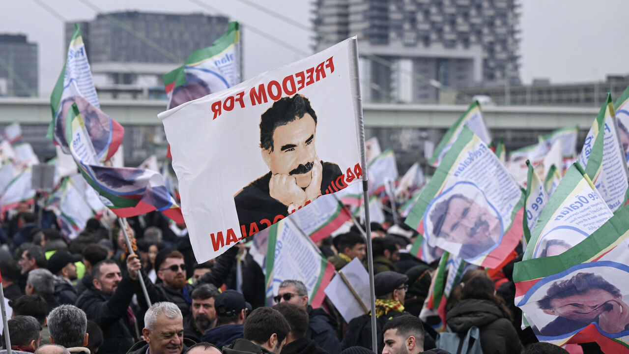 Thousands of supporters of the Kurdish community demonstrate with flags and banners on the occasion of the 25th anniversary of the arrest of Kurdistan Workers Party (PKK) leader Abdullah Ocalan on the banks of the Rhine river in Cologne, western Germany, on Feb. 17, 2024. 