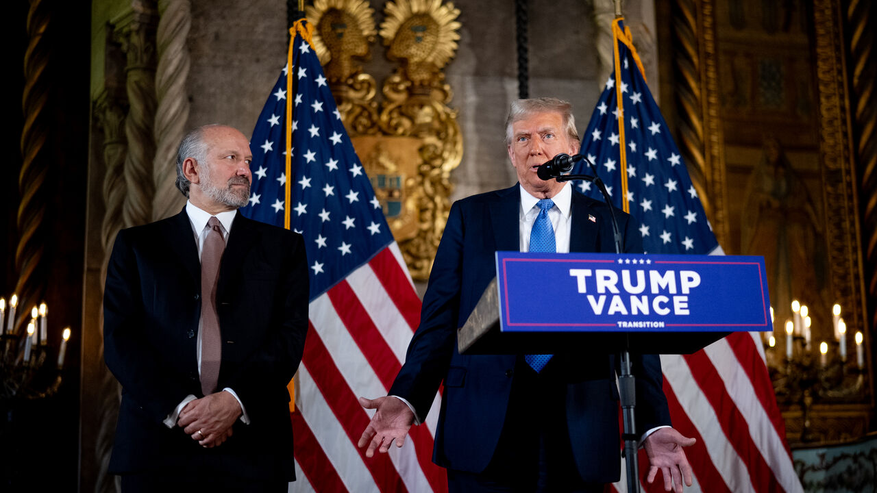 PALM BEACH, FLORIDA - DECEMBER 16: U.S. President-elect Donald Trump, accompanied by Trump's choice for Secretary of Commerce, Cantor Fitzgerald Chairman and CEO Howard Lutnick, speaks at a news conference at Trump's Mar-a-Lago resort on December 16, 2024 in Palm Beach, Florida. In a news conference that went over an hour, Trump announced that SoftBank will invest over $100 billion in projects in the United States including 100,000 artificial intelligence related jobs and then took questions on Syria, Israe