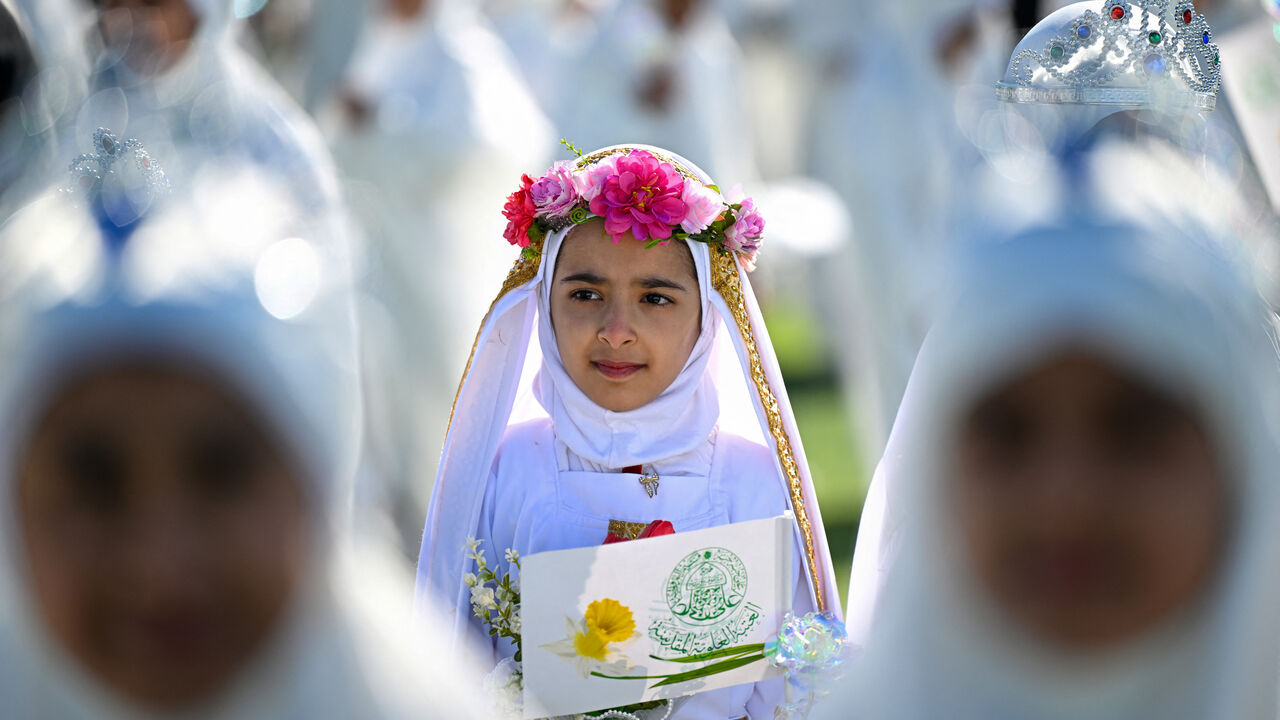 Iraqi Muslim girls, who traditionally begin wearing the hijaba head covering worn in publicat the mandatory age of nine, take part in a ceremony organized at a stadium in Basra on December 19, 2024. (Photo by Hussein FALEH / AFP) (Photo by HUSSEIN FALEH/AFP via Getty Images)