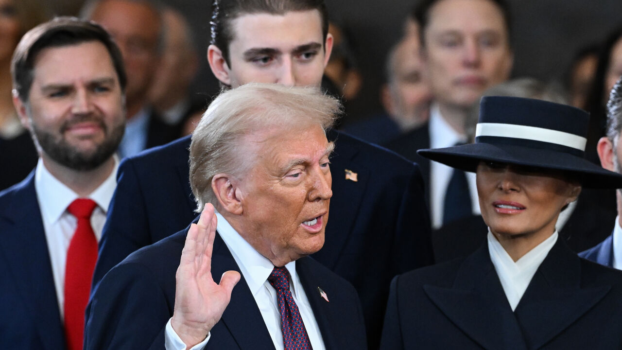 WASHINGTON, DC - JANUARY 20: Donald Trump is sworn into office as Melania Trump holds the Bible in the U.S. Capitol Rotunda on January 20, 2025 in Washington, DC. Donald Trump takes office for his second term as the 47th president of the United States. (Photo by Saul Loeb - Pool/Getty Images)