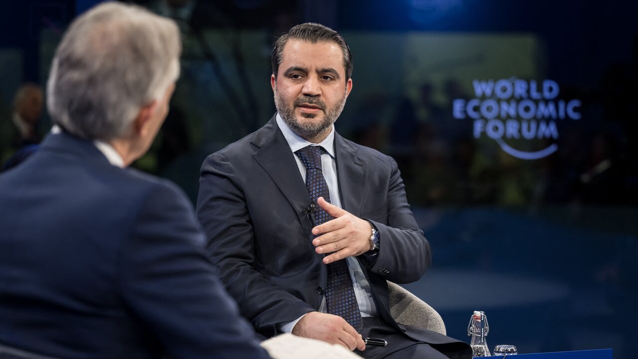 Syrian Foreign Minister Asaad al-Shibani speaks to former British Prime Minister Tony Blair at a session during the World Economic Forum annual meeting in Davos on Jan. 22, 2025. 