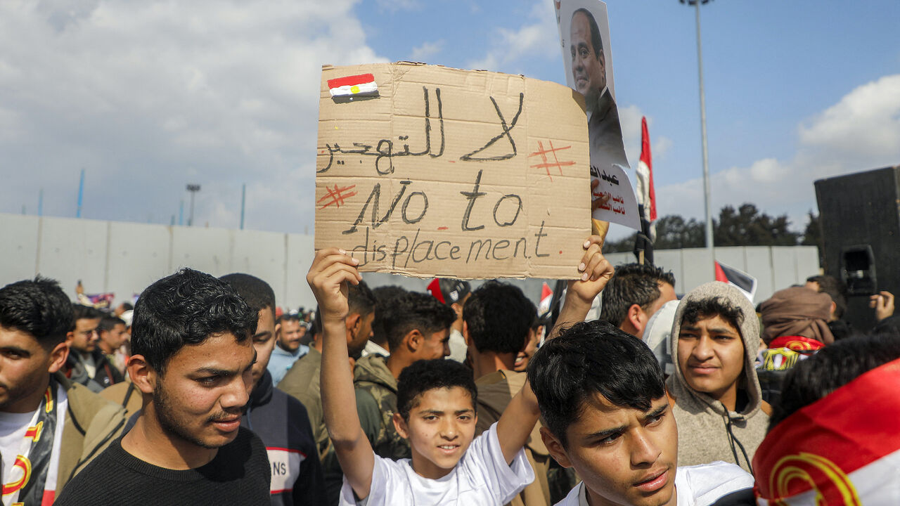 Demonstrators gather outside the Egyptian side of the Rafah border crossing with the Gaza Strip on Jan. 31, 2025 to protest against a plan floated by US President Donald Trump to move Palestinians from the Gaza Strip to Egypt and Jordan.