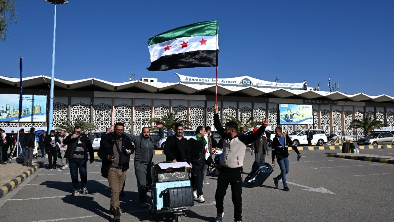 Travellers are welcomed at Damascus's airport, which resumed international flights on Tuesday Travellers are welcomed at Damascus's airport, which resumed international flights on Tuesday