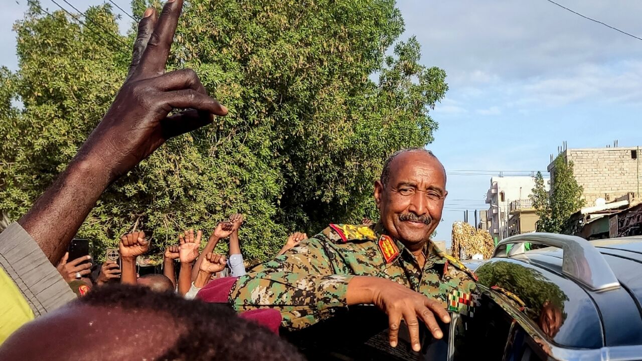 People cheer Sudan's de facto leader, armed forces chief Abdel Fattah al-Burhan, at the market in Port Sudan on December 29, 2024