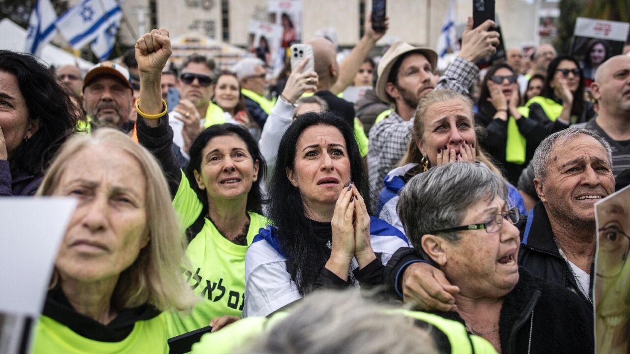 Relatives and friends of Israeli hostages watch the release of four women soldiers from captivity in Gaza, on a screen at 'Hostage Square' in Tel Aviv Relatives and friends of Israeli hostages watch the release of four women soldiers from captivity in Gaza, on a screen at 'Hostage Square' in Tel Aviv