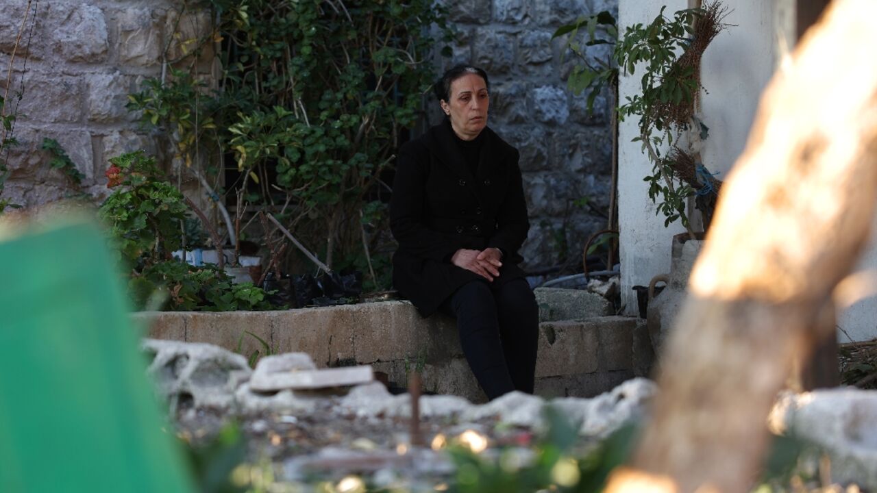 Nisrine Ezzedine sits in her garden where her husband, son and nephew are buried