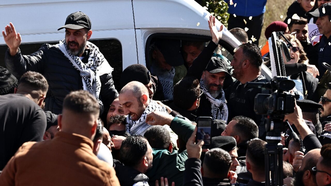 A cheering crowd hoisted freed Palestinian prisoners onto their shoulders after they arrived in the occupied West Bank city of Ramallah