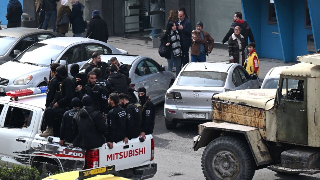 Security forces with Syria's new government patrol in Damascus on February 3, 2025