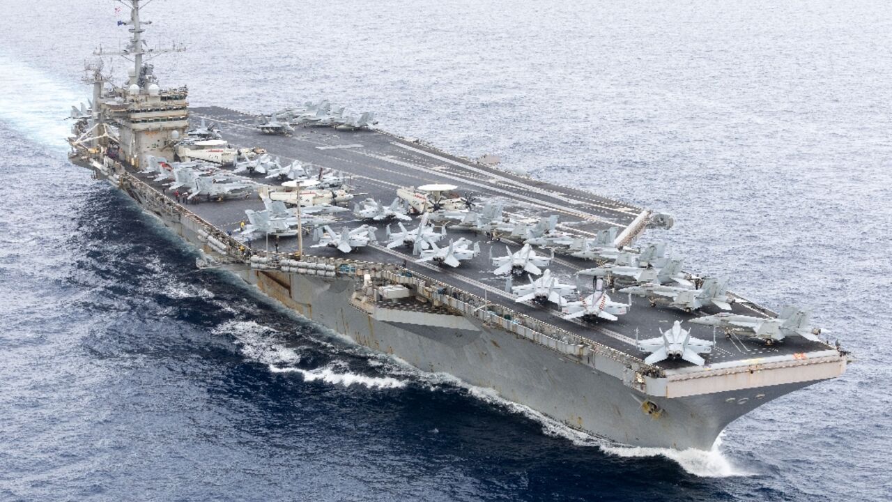 An image provided by the US Navy shows the USS Harry S. Truman aircraft carrier transiting the Strait of Gibraltar on November 25, 2024