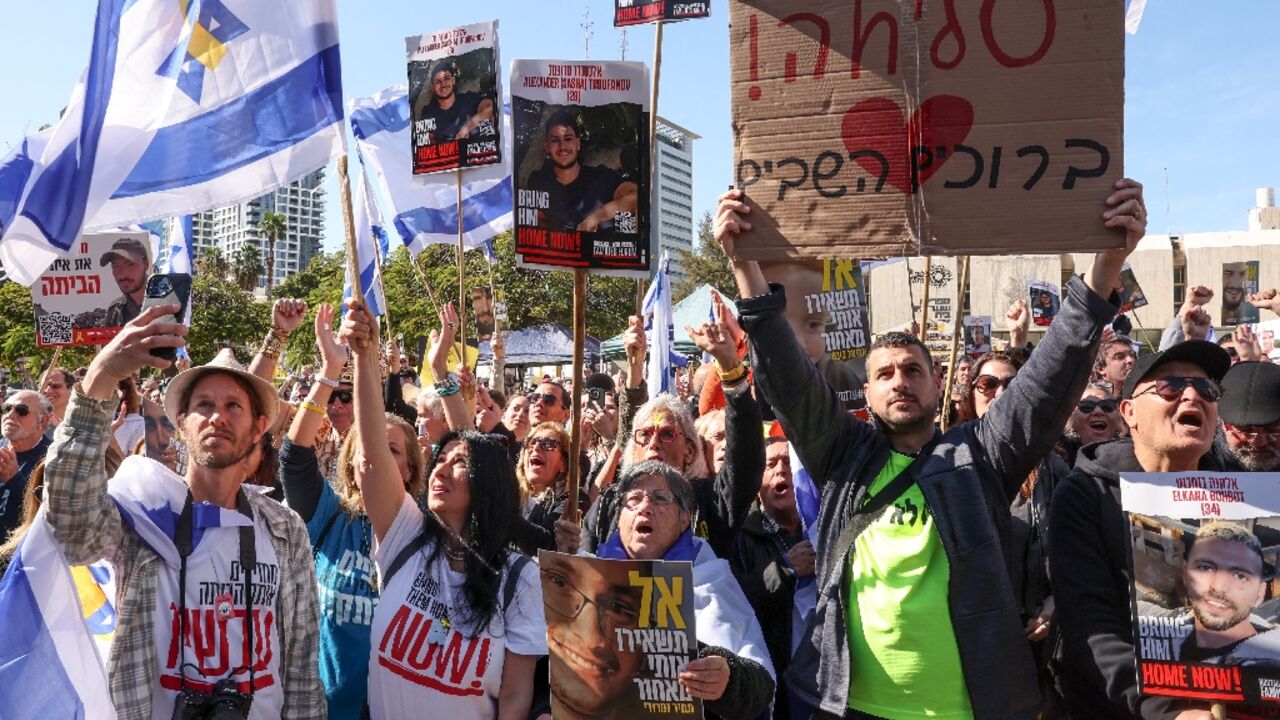 People gather at Tel Aviv's "Hostages Square" to watch the release of three Israelis held by Palestinian militants in Gaza