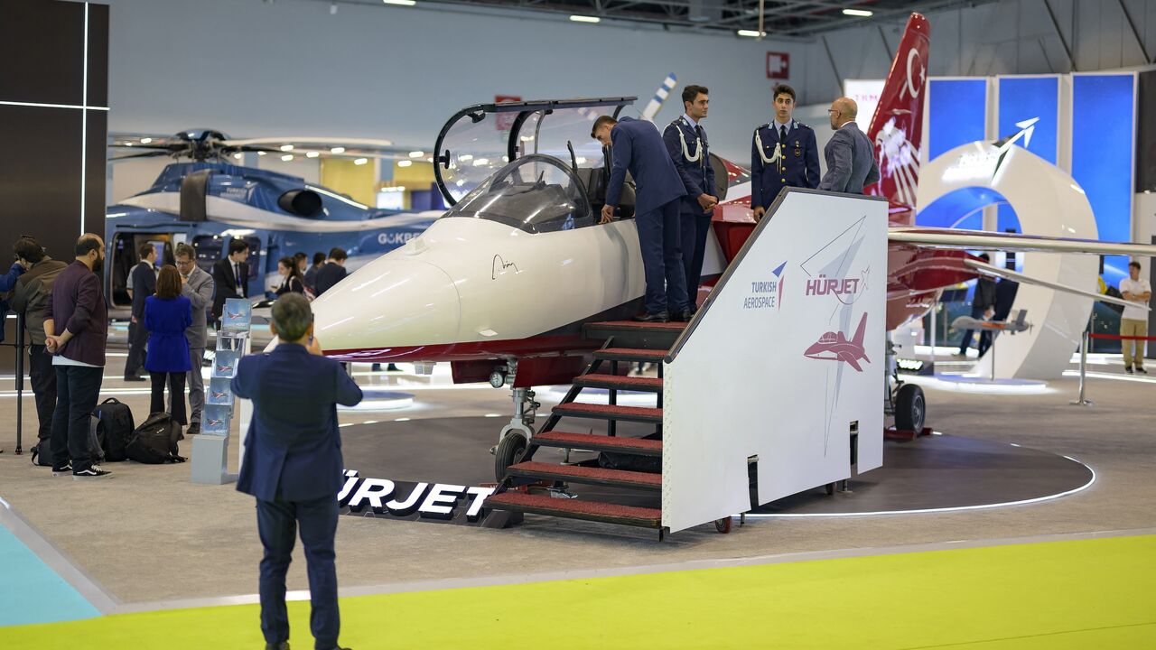 People look advanced jet trainer light attack aircraft "Hurjet" during the opening day of the International Defence and Aerospace exhibition in Istanbul on Oct. 22, 2024. 