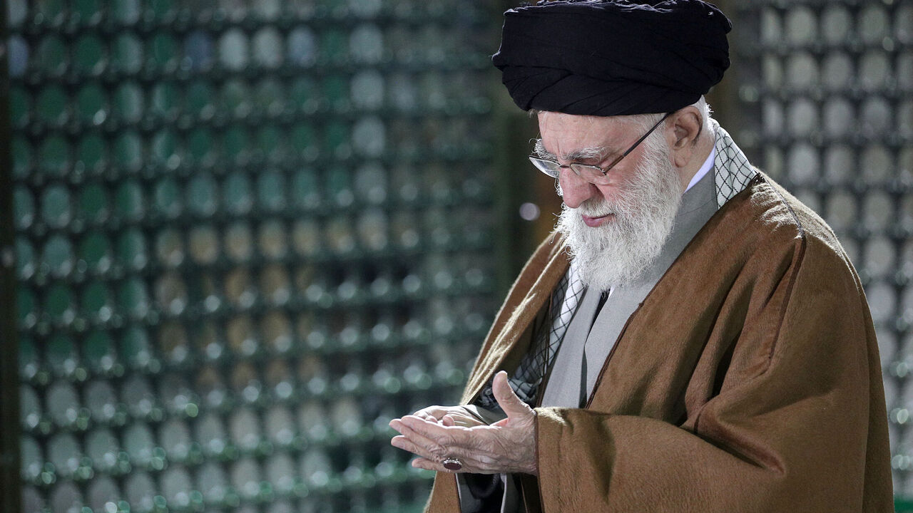 This handout picture provided by the office of Iranian Supreme Leader Ayatollah Ali Khamenei shows him praying inside the tomb of the late Supreme Leader Ayatollah Ruhollah Khomeini in Tehran on Jan. 30, 2025. 