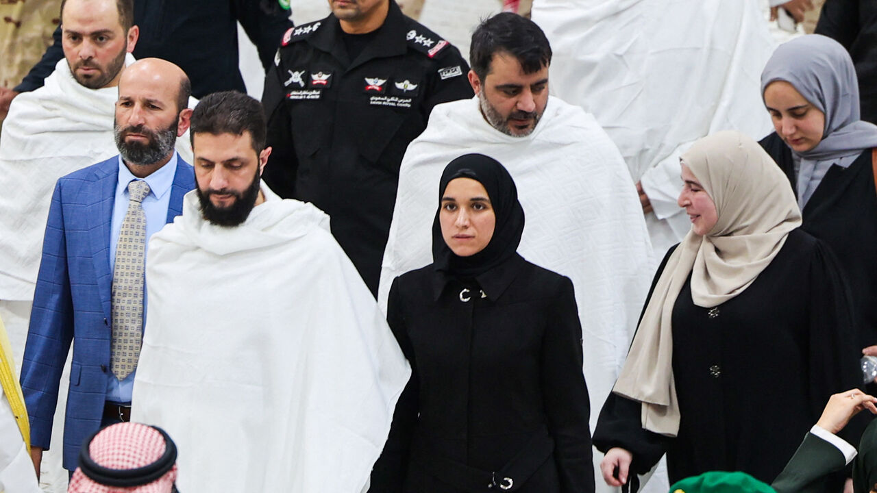 Syria's interim president Ahmed al-Sharaa (front L) accompanied by his wife Latifa al-Droubi (front C), and Foreign Minister Asaad al-Shaibani perform the Umrah, or the minor pilgrimage, alongside their wives respectively and in Islam's holiest city of Mecca in western Saudi Arabia on February 3, 2025. 