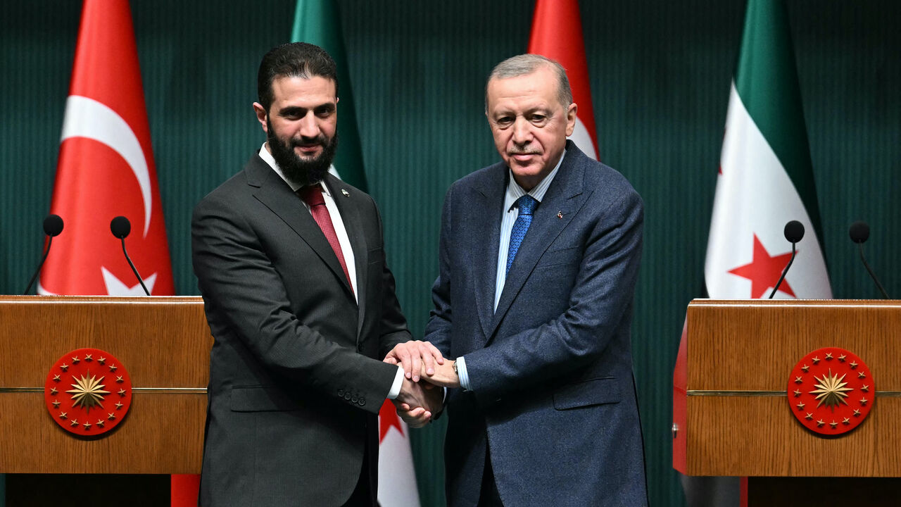 Turkish President Recep Tayyip Erdogan (R) and Syria's interim president Ahmed al-Sharaa shake hands during a joint press conference following their meeting at the Presidential Palace in Ankara, on February 4, 2025. 