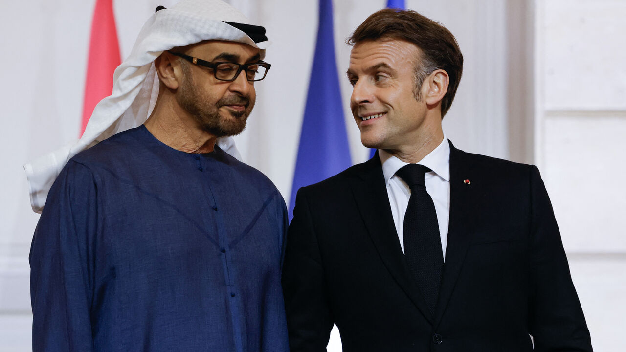 UAE President Sheikh Mohamed bin Zayed al-Nahyan (L) and French President Emmanuel Macron talk as they attend an agreement signing ceremony as part of Zayed al-Nahyan's visit to France at the presidential Elysee palace in Paris, on Feb. 6, 2025.