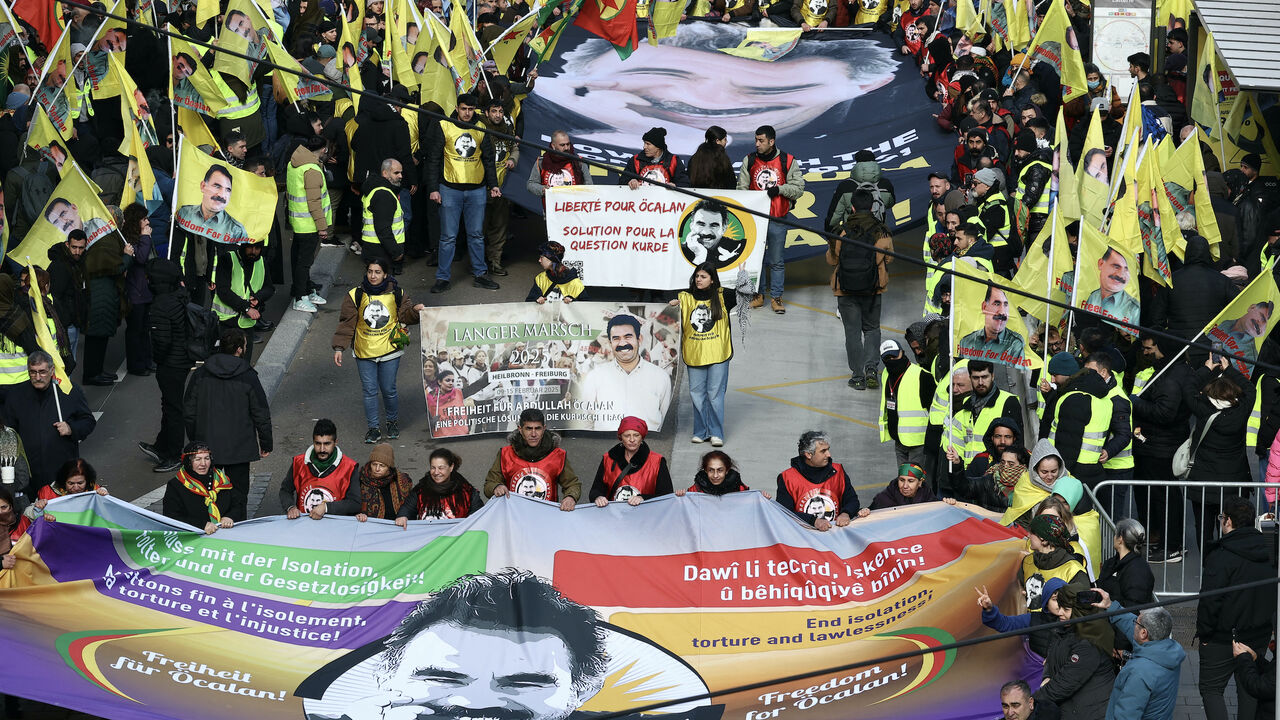 Kurds hold the edges of large banners depicting Kurdistan Worker's Party (PKK) leader Abdullah Ocalan during a demonstration of several thousand people from all around Europe to mark the 26th anniversary of the arrest of PKK founder and to demand his liberation in Strasbourg, Eastern France, on Feb. 15, 2025. 