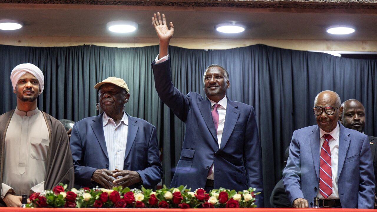 Abdul Rahim Hamdan Dagalo (C), Sudan's Rapid Support Forces deputy commander and brother to Mohamed Hamdan Dagalo (also known as Hemedti), flanked by representatives of other political parties affiliated to Sudan's Rapid Support Forces (SRF) react as they arrive at the venue ahead of their planned signing of the Government of Peace and Unity Charter, at the Kenyatta International Convention Centre (KICC) in Nairobi on February 18, 2025. (Photo by SIMON MAINA / AFP) (Photo by SIMON MAINA/AFP via Getty Images