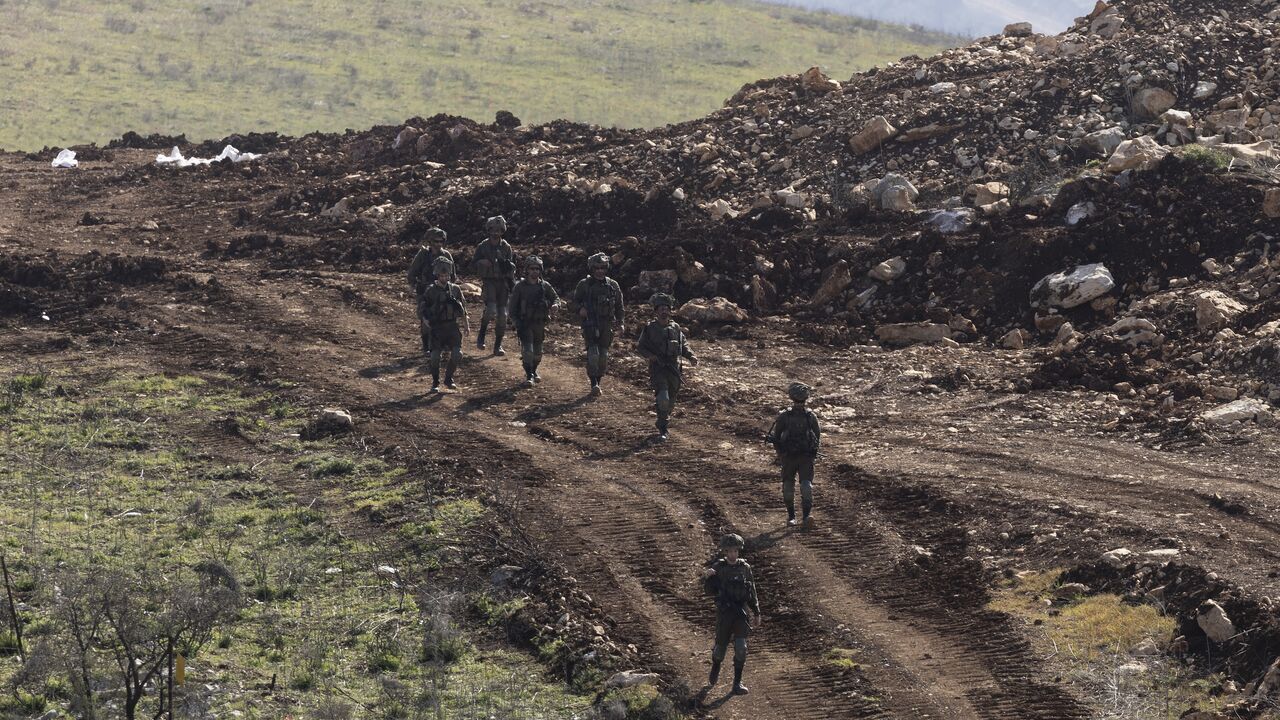  Israeli soldiers walk along the buffer zone between northern Israel and southern Lebanon, Feb. 18, 2025. 