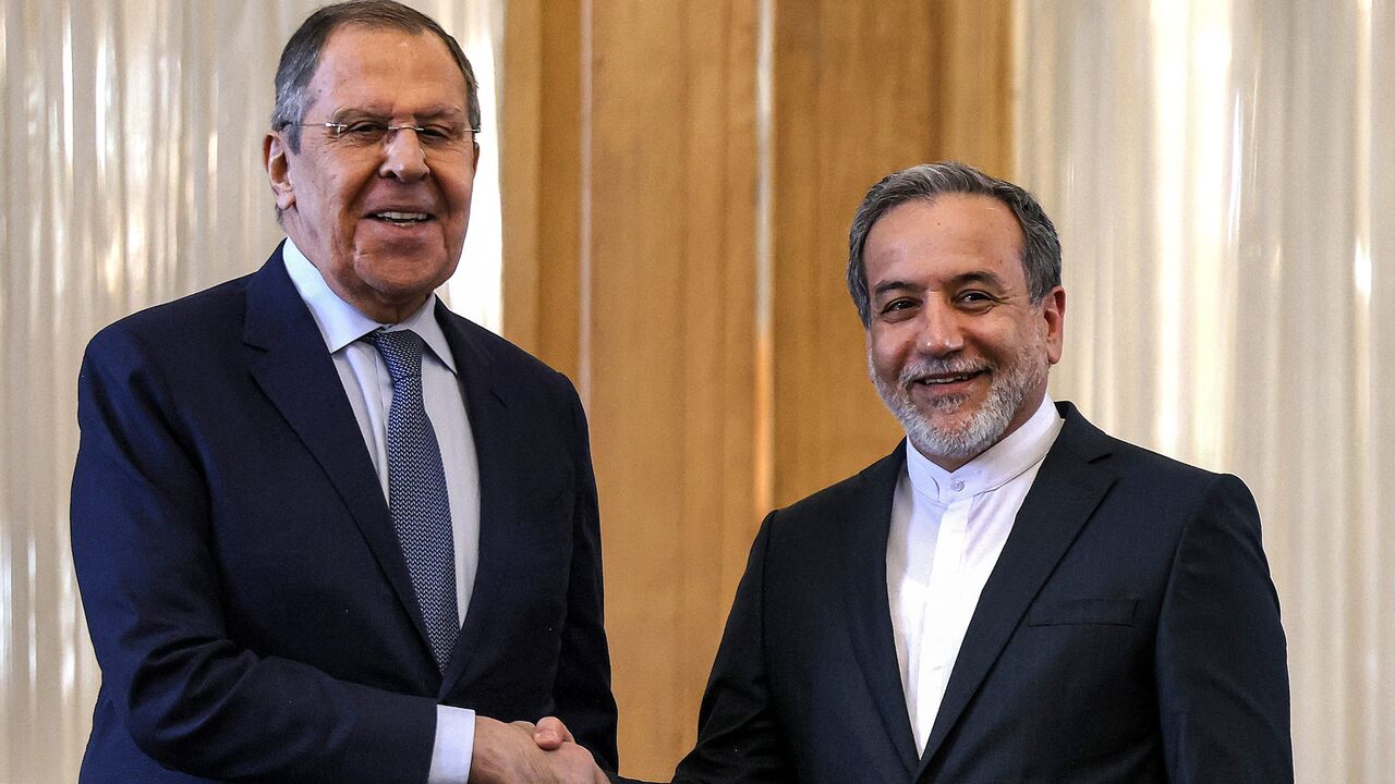 Iran's Foreign Minister Abbas Araghchi shakes hands with Russia's Foreign Minister Sergey Lavrov.