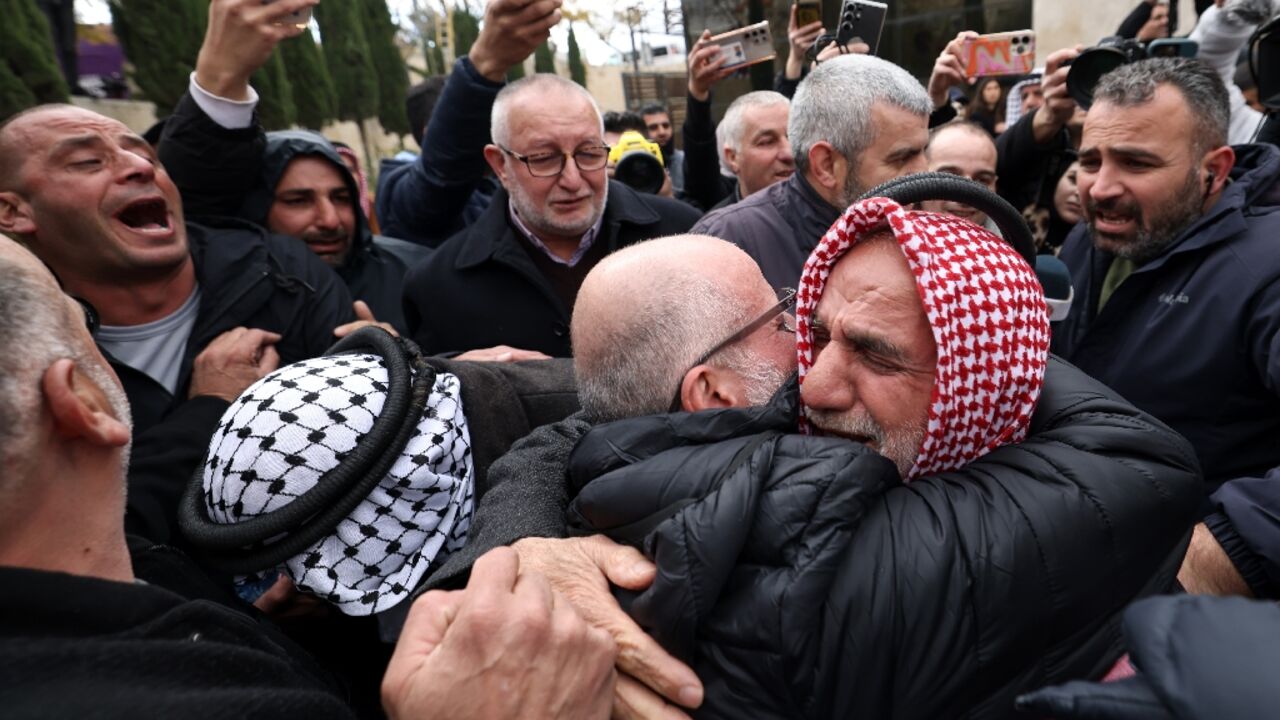 A former Palestinian prisoner hugs a member of his family in the occupied West Bank city of Ramallah following his release from an Israeli prison