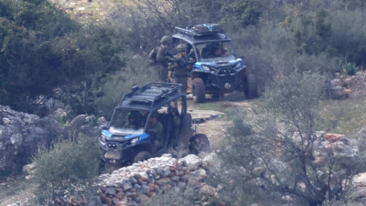 Israeli army forces patrol in the village of Kfarshuba, southern Lebanon, the day before a deadline for withdrawal of its troops