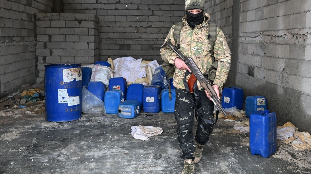 A member of the Syrian security forces searches a defunct drug factory inside an abandoned building in the countryside of Qusayr, at the porous Lebanese border