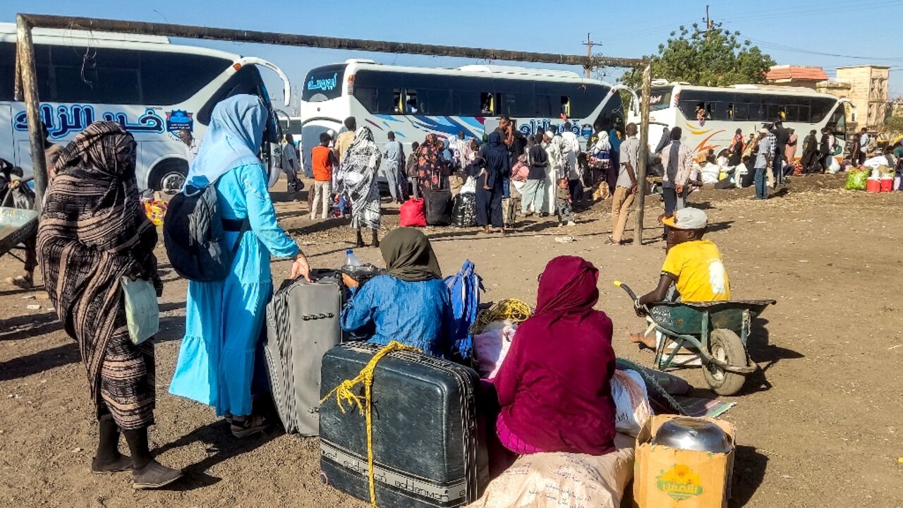 People displaced by the war in Sudan prepare to board buses home to Wad Madani in Jazira state after it was retaken by the army from the RSF