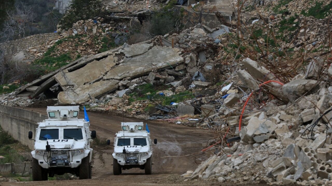 United Nations peacekeepers drive past the rubble of buildings in the southern Lebanese village of Yarine during the ceasefire between Israel and Hezbollah